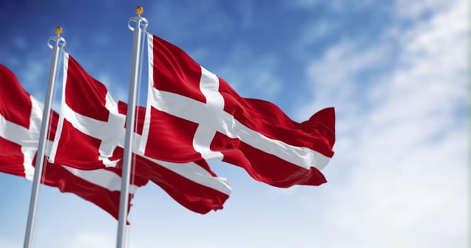 Three Denmark national flags waving in the wind on a clear day. The Kingdom of Denmark is a Nordic country in Northern Europe. Fluttering fabric. 3d illustration render