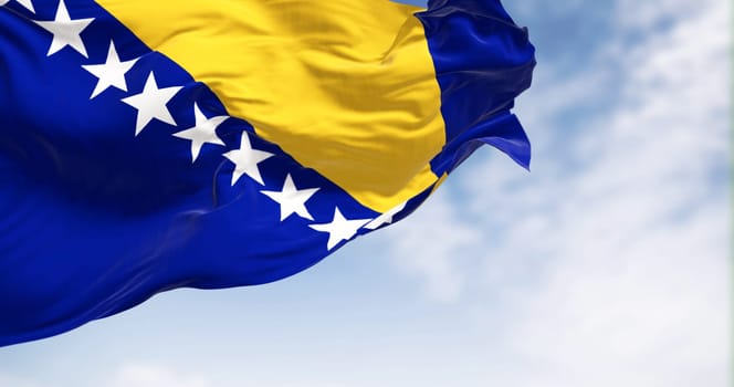 Flag of Bosnia and Herzegovina waving in the wind. Blue field with yellow triangle and white stars. 3d illustration render. Fluttering textile
