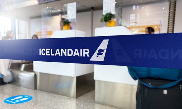 Reykjavík, IS Jan 2023: Blue barrier tape with the Icelandair logo inside an airport. Icelandair is the flag carrier airline of Iceland. Travel and airport security. Illustrative editorial