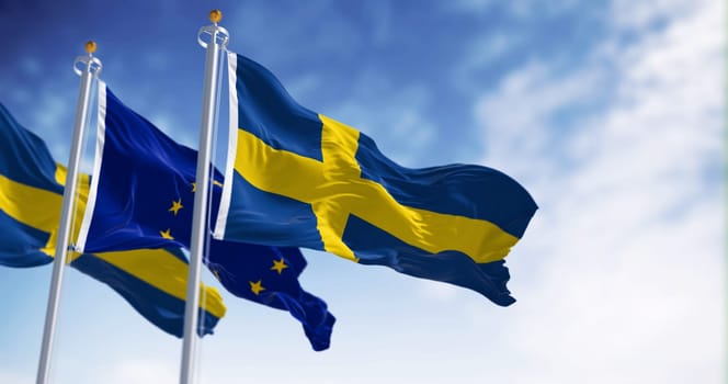The flags of Sweden and the European Union waving together on a clear day. Sweden became a member of the European Union on January 1, 1995. Realistic 3d illustration