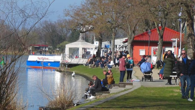 CAPUTH, Germany, Brandenburg, April 0, 2023. The most popular waterfront in Caputh at the river Havel with cable ferry port. The river Havel connects the lake Schwielow with the Templiner lake and is a popular travel destination. Macro.