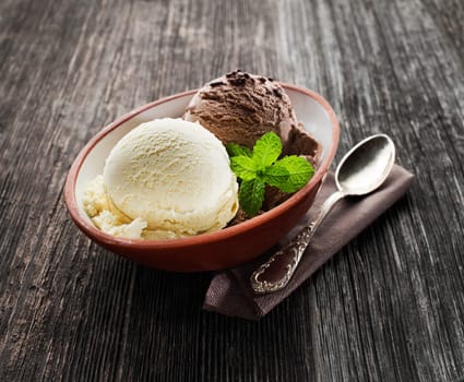 Vanilla and chocolate Ice cream on wooden background.