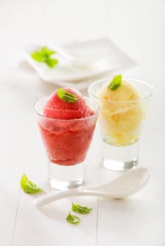 Fresh mixed fruit ice cream sorbet in glass.