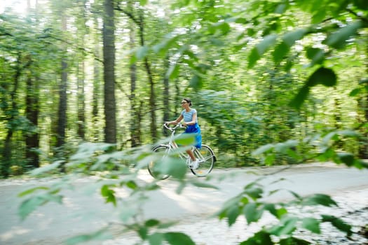 Young woman riding bicycle on summer weekend