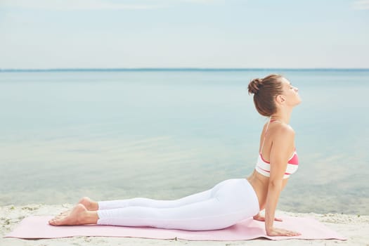 Fit woman doing stretching yoga exercise