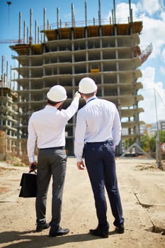 Two architects standing in front of new construction