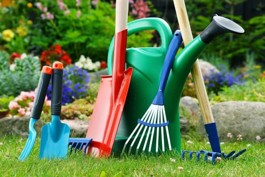 Watering can and tools in the garden