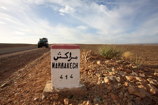 Road Sign to Marrakech in Morocco with blue sky