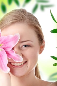 Portrait of young beautiful blond woman with lily flower