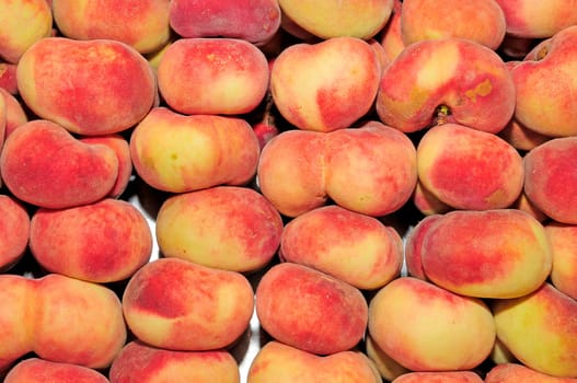 a pile of chinese flat peaches ready to sell