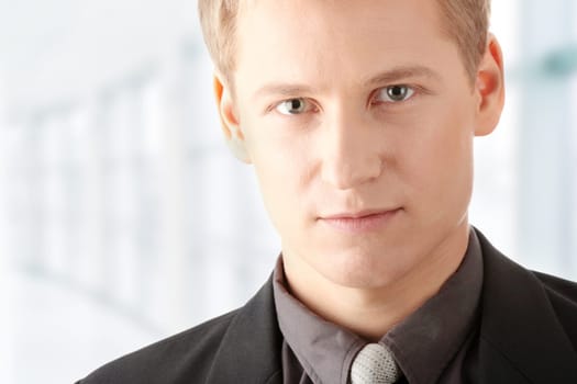 Closeup of a smart handsome business man over white background