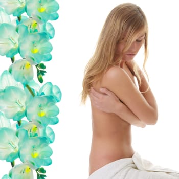 Beautiful young naked woman covered by towel - spa concept, against abstract flower background
