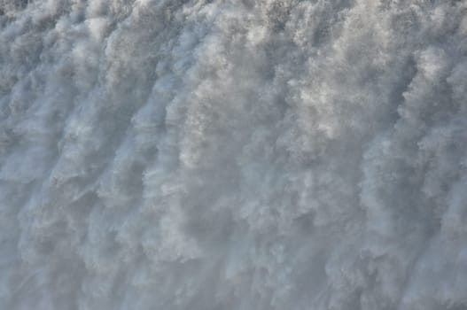 Closeup of a massive, foamy waterfall in Iceland
