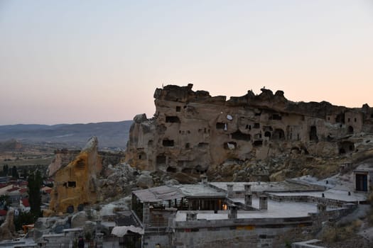 View of the Cavusin Rock Church at sunset in Cavusin, Cappadocia, Turkey