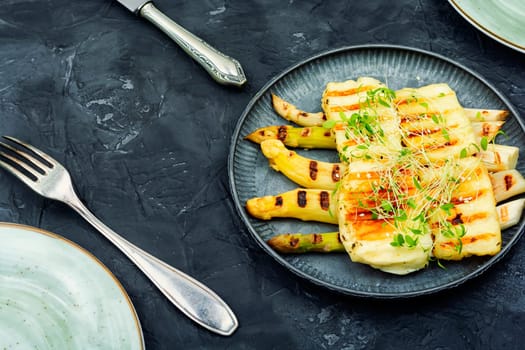 Grilled halloumi cheese and white asparagus. Space for text