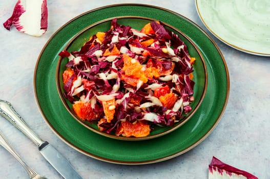 Raw chicory salad with grapefruit and pine nuts on a plate