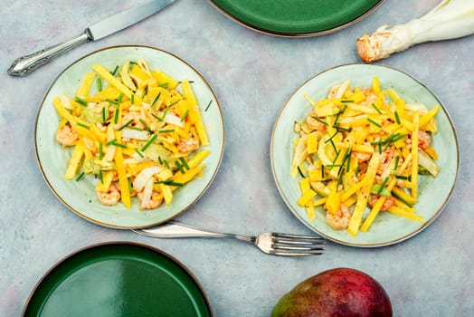 Dieting salad of mango, avocado, grilled shrimp and pine nuts.