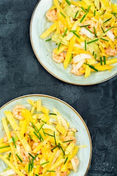 Dieting salad of mango, avocado, grilled shrimp and pine nuts.