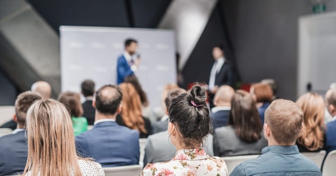 Pitch presentation and project discussion at business convention or team meeting. Audience at the conference hall. Business and entrepreneurship symposium