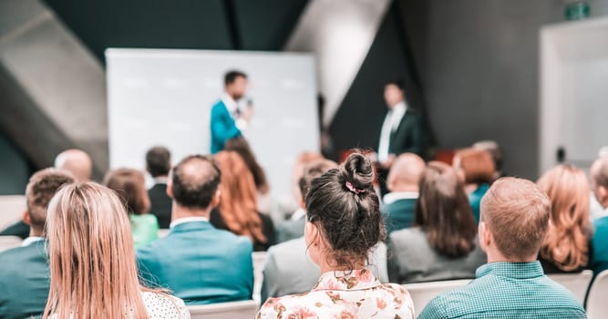Pitch presentation and project discussion at business convention or team meeting. Audience at the conference hall. Business and entrepreneurship symposium