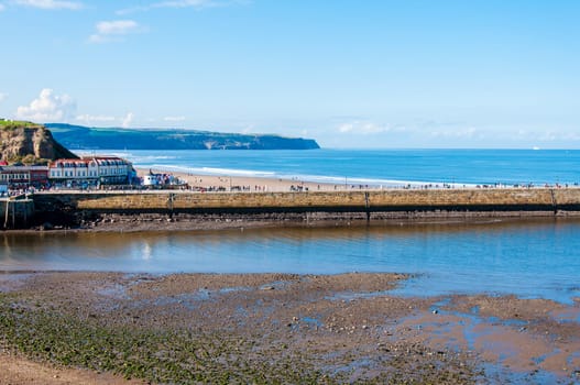 Scenic view of Whitby Pier in sunny autumn day.Whitby's attraction as a tourist destination is enhanced by its association with the world famous horror novel Dracula, written by Bram Stoker
