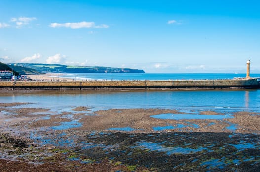 Scenic view of Whitby Pier in sunny autumn day.Whitby's attraction as a tourist destination is enhanced by its association with the world famous horror novel Dracula, written by Bram Stoker