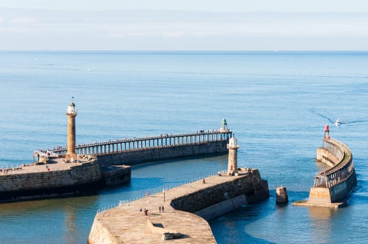 Scenic view of Whitby Pier in sunny autumn day.Whitby's attraction as a tourist destination is enhanced by its association with the world famous horror novel Dracula, written by Bram Stoker
