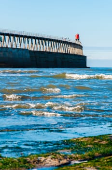 Scenic view of Whitby Pier in sunny autumn day.Whitby's attraction as a tourist destination is enhanced by its association with the world famous horror novel Dracula, written by Bram Stoker
