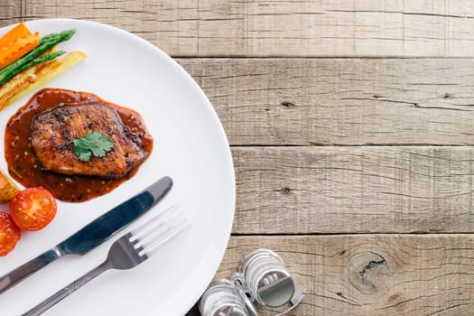 beef steak in dish on wood table