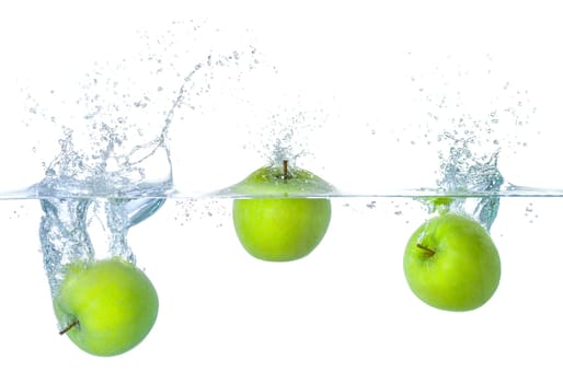 Apples fall into the water with splashes