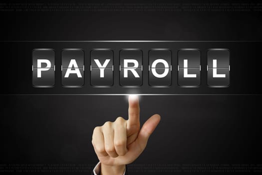 business hand pushing payroll on Flipboard Display