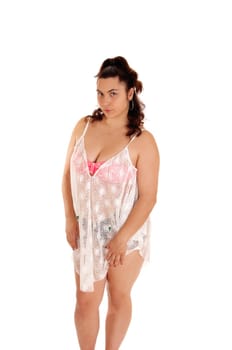 A pretty young woman in a pink bikini top and black pantie, with a white.lace shirt, standing isolated for white background..