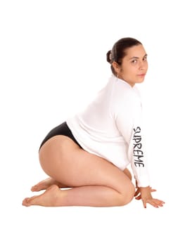 A pretty woman in short white shirt and black panties kneeling on the.floor, isolated for white background..