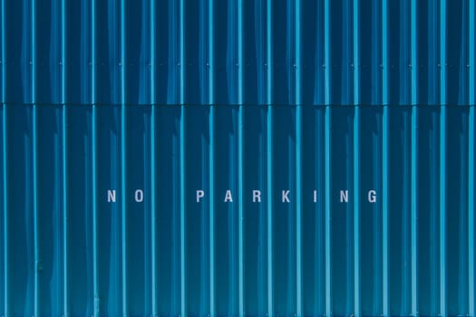 No parking printed on blue siding.