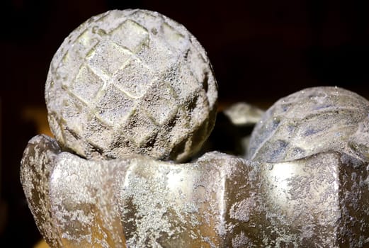 Christmas tree balls in a bowl. A silver decoration against a black background.