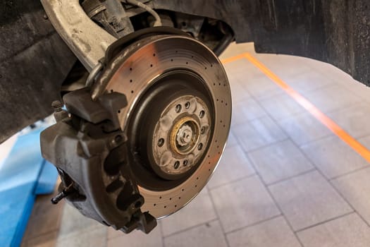 Close-up shot of a mechanic replacing a disc brake on a car