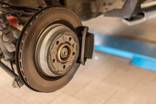 Close-up shot of a mechanic replacing a disc brake on a car