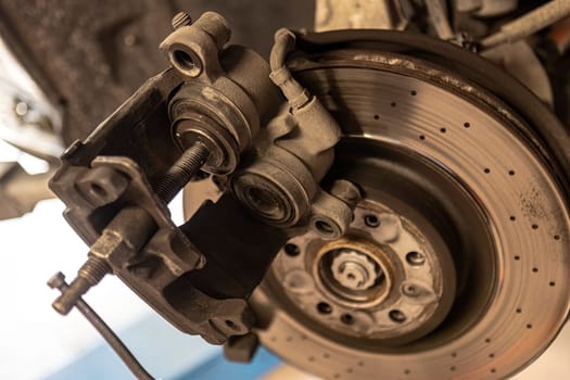 Close-up shot of a mechanic replacing a disc brake on a car