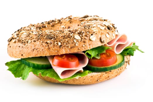 Freshly made sandwich with ham and vegetables over white background
