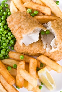 Fried fish and chips with lemon and peas