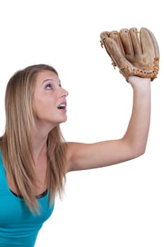 A beautiful woman catchinging a baseball at a ball field