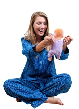 A young Beautiful Woman playing with a baby doll