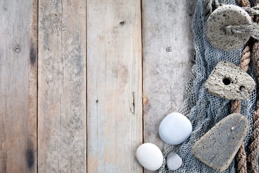 Cork, fishing net and rope with wooden background