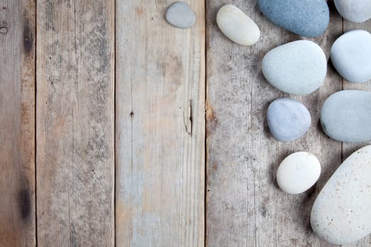 Stones with shadow on wooden background