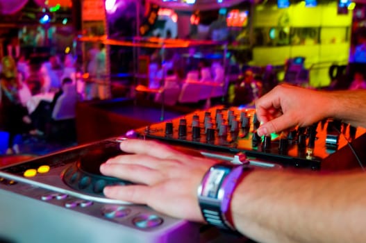 Dj playing the track in the nightclub at a party