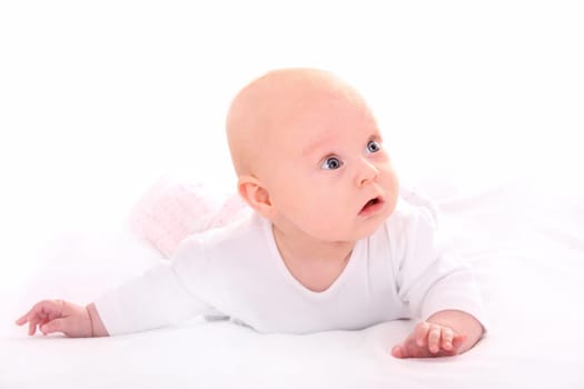 A picture of a nice small baby girl looking with curiosity over white background