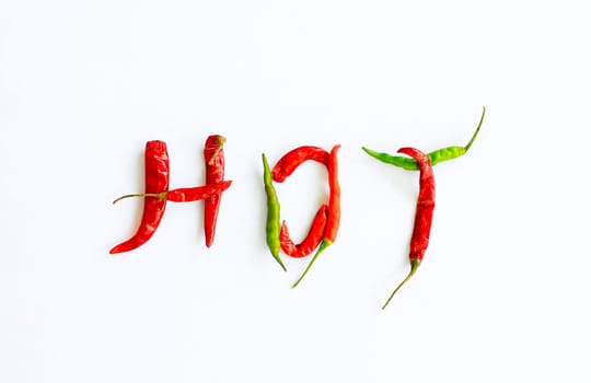 Fresh and dried chili peppers on a white background