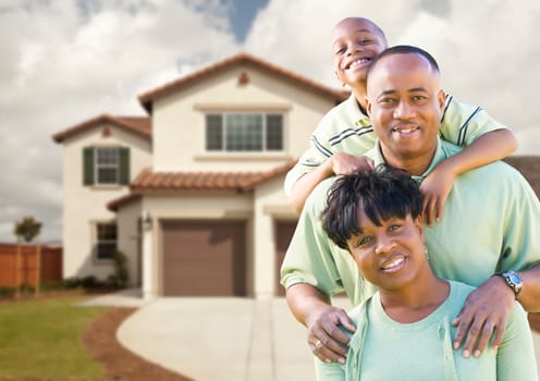 Attractive African American Family in Front of Beautiful House.