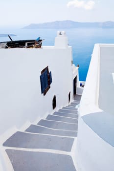 Steps going down in Thira, Santorini, Greece with caldera in the background