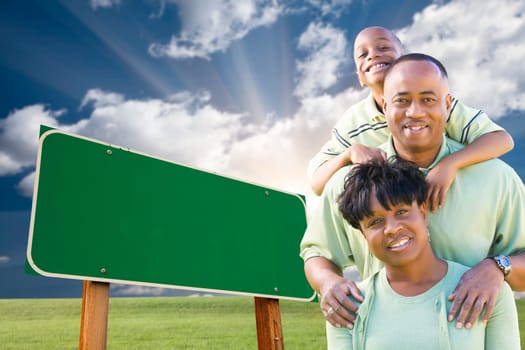 Attractive African American Family in Front of Blank Green Road Sign Ready for Your Own Message.